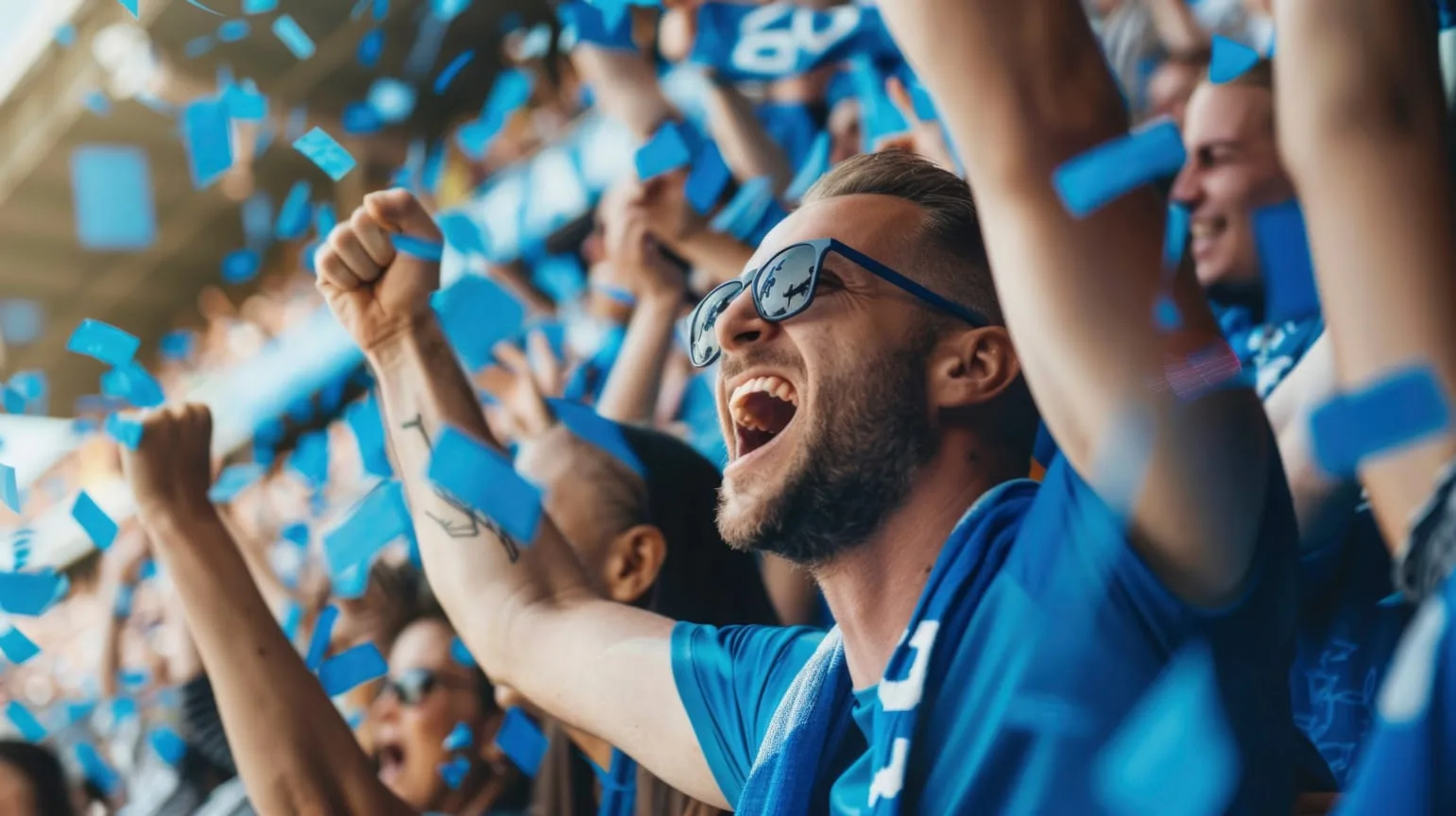 Football fans celebrating in the stadium